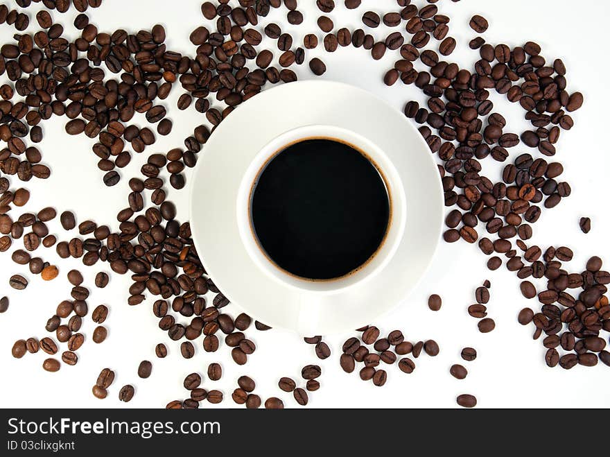 Coffee cup and coffee beans on white background