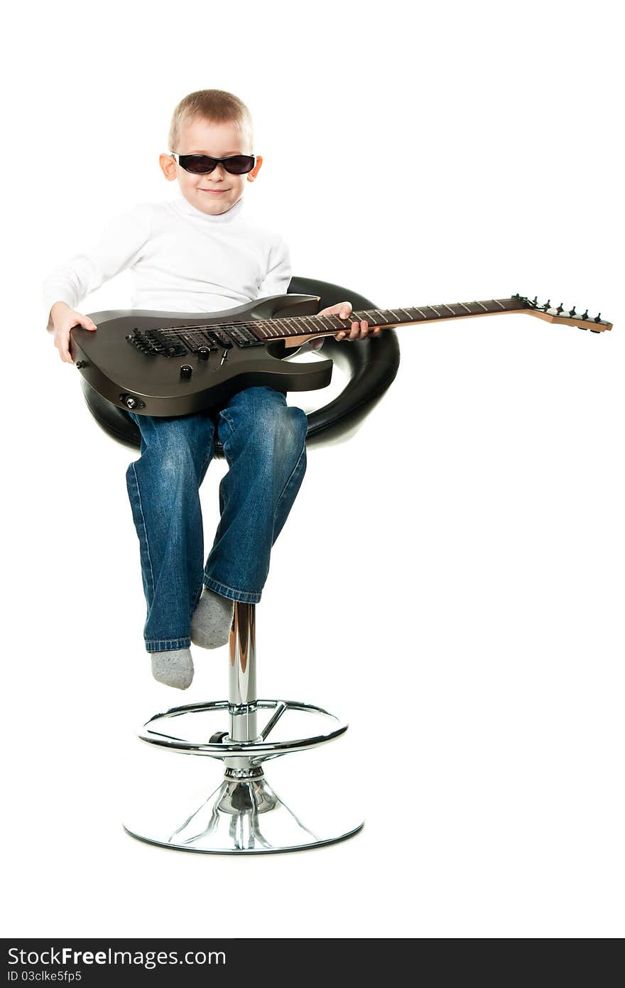 Cute little boy holding a guitar