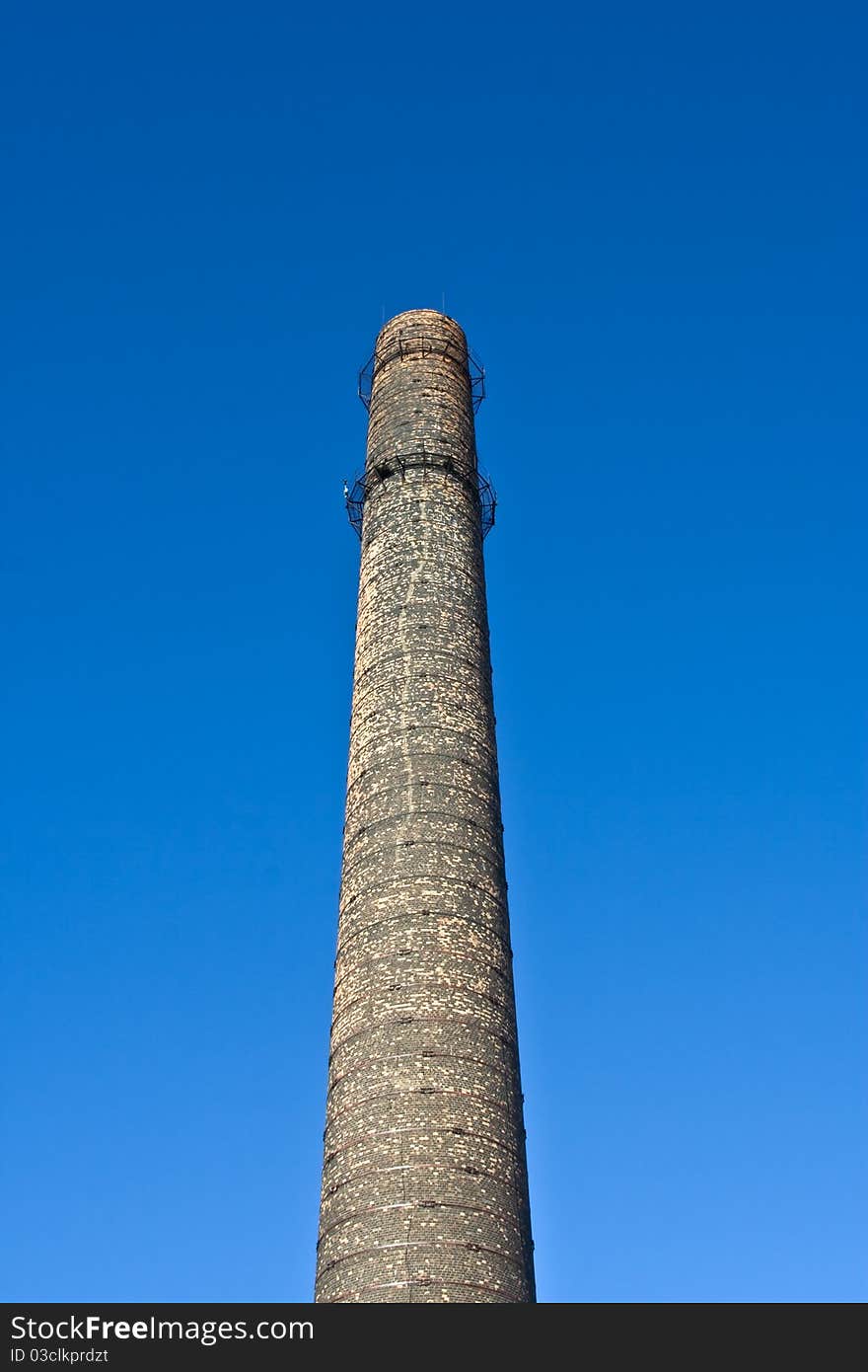 Old chimney-stalk on a background blue sky. Old chimney-stalk on a background blue sky