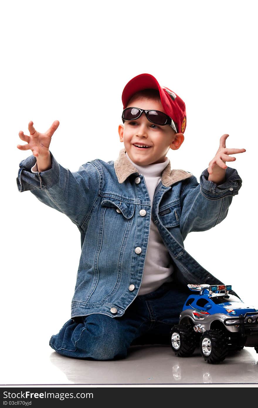 Cute little boy playing with car isolated on white