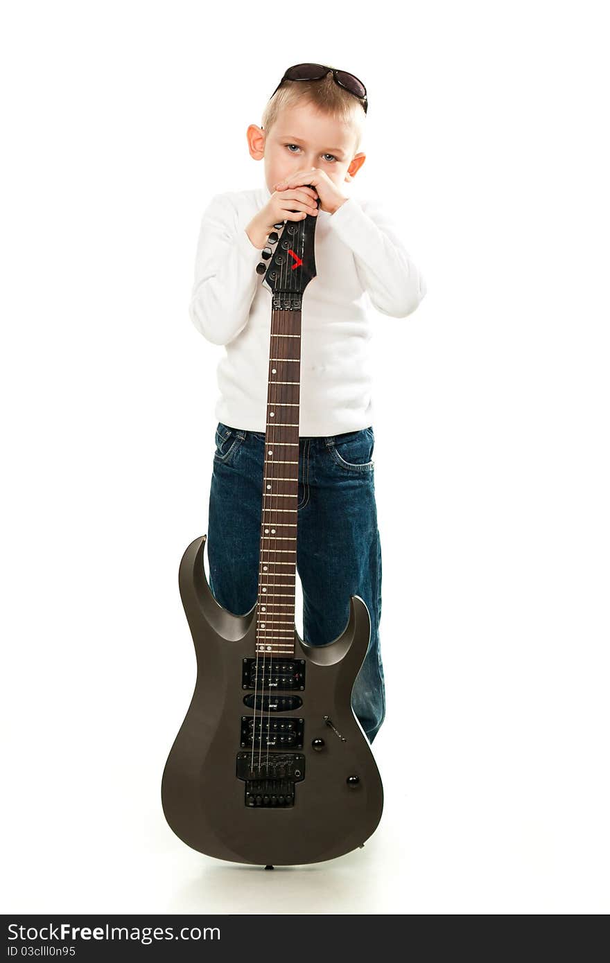 Cute little boy holding a guitar isolated on white