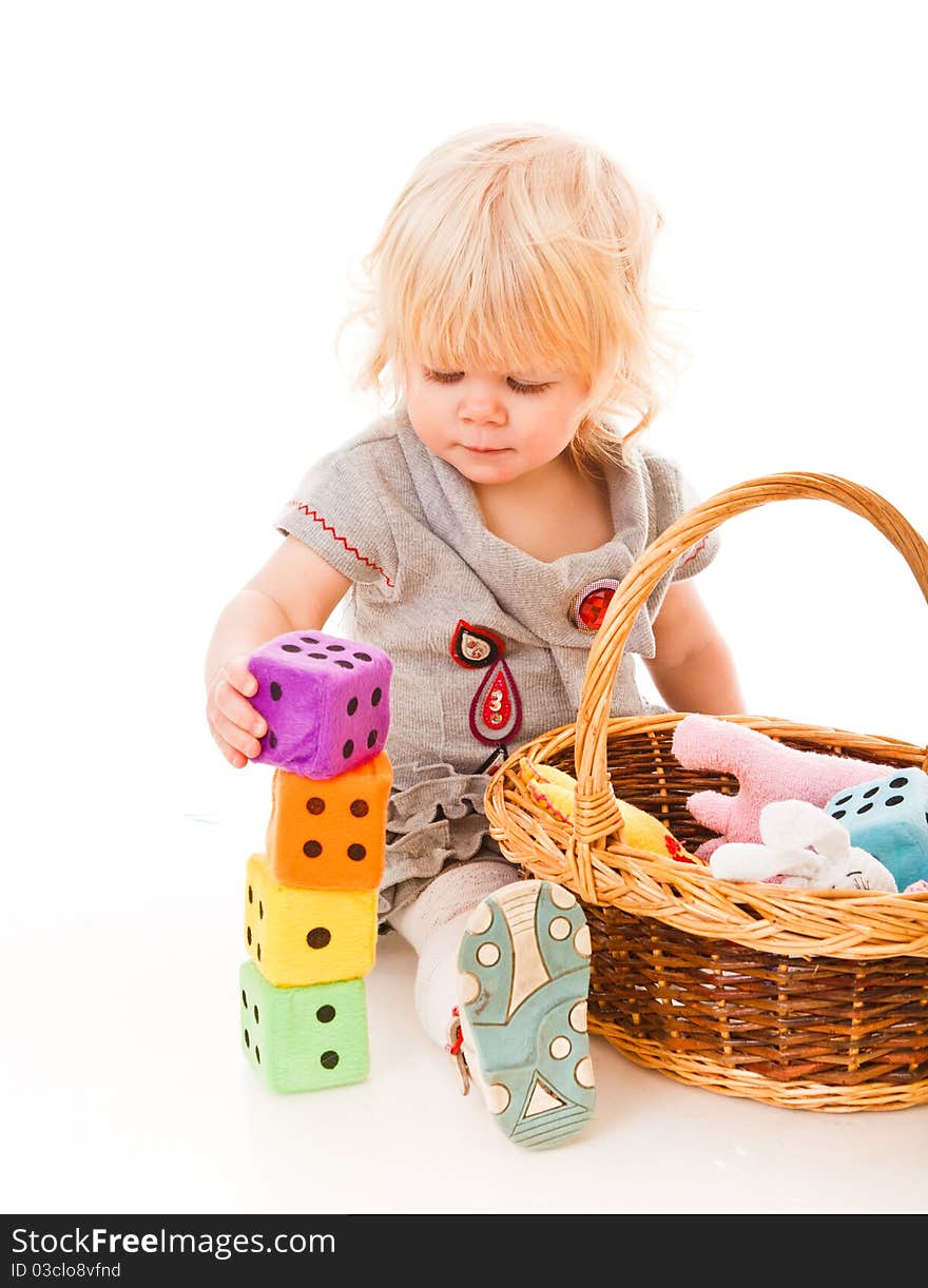 Little blonde haired girl playing with toys. Little blonde haired girl playing with toys