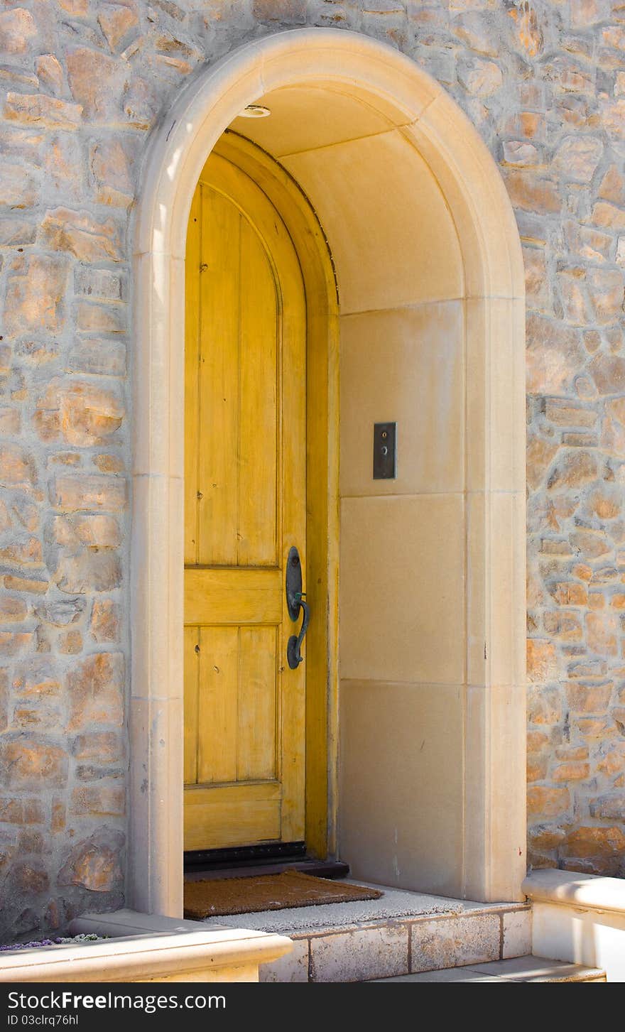 An elegant wooden door on a stone house. An elegant wooden door on a stone house