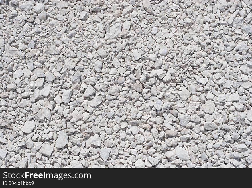 Grayish-white gravels, filling up the whole frame. Grayish-white gravels, filling up the whole frame