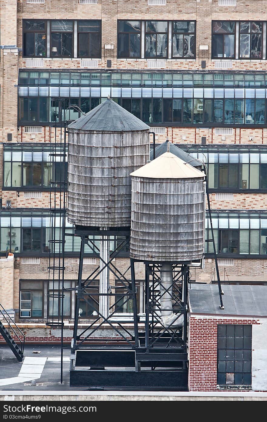 Cropped view of buildings in New York City and rooftop water towers. Cropped view of buildings in New York City and rooftop water towers.