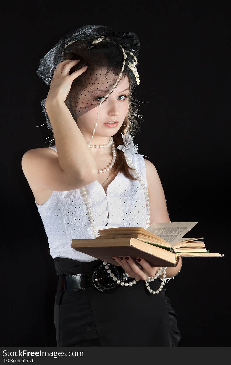 Vintage portrait young woman in a hat and a book. Vintage portrait young woman in a hat and a book.