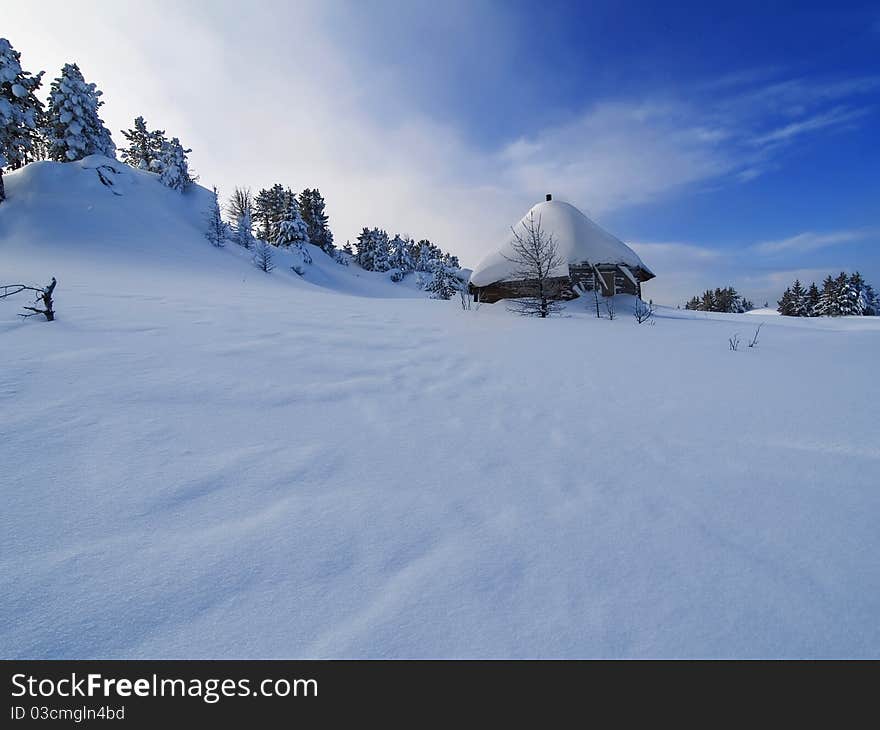 Hut in the mountains in the snow