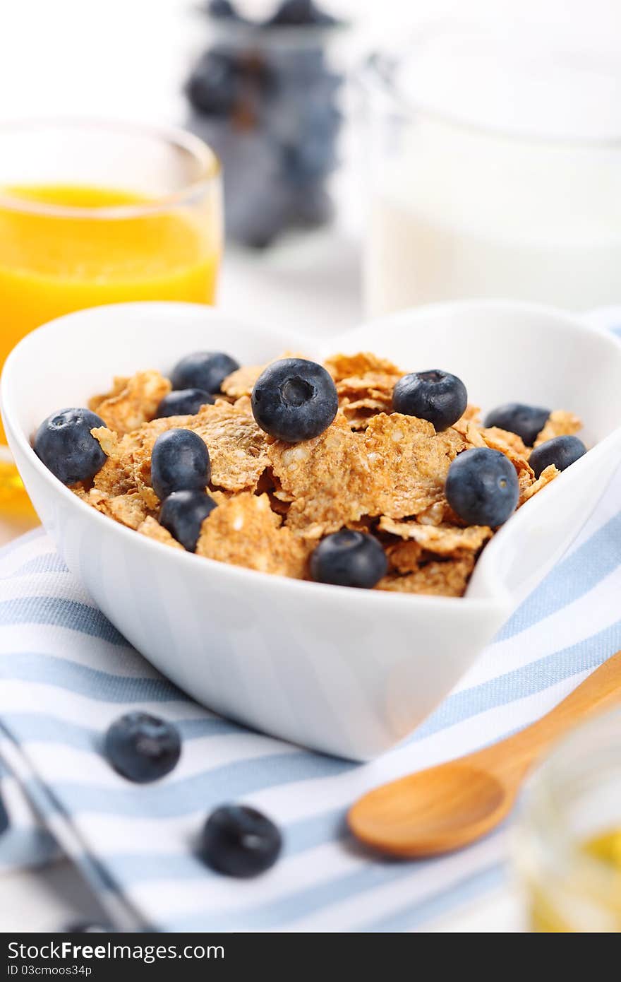 Healthy breakfast- cereal with fresh blueberries, juice and milk