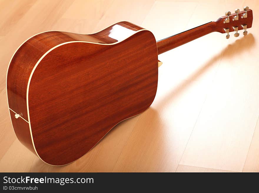 Brown guitar on neutral background