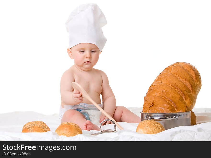 Little boy chef with spoon and bread