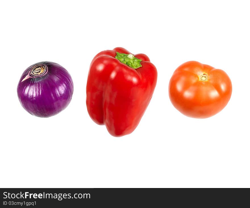 A red onion, capsicum and tomato isolated against a white background. A red onion, capsicum and tomato isolated against a white background