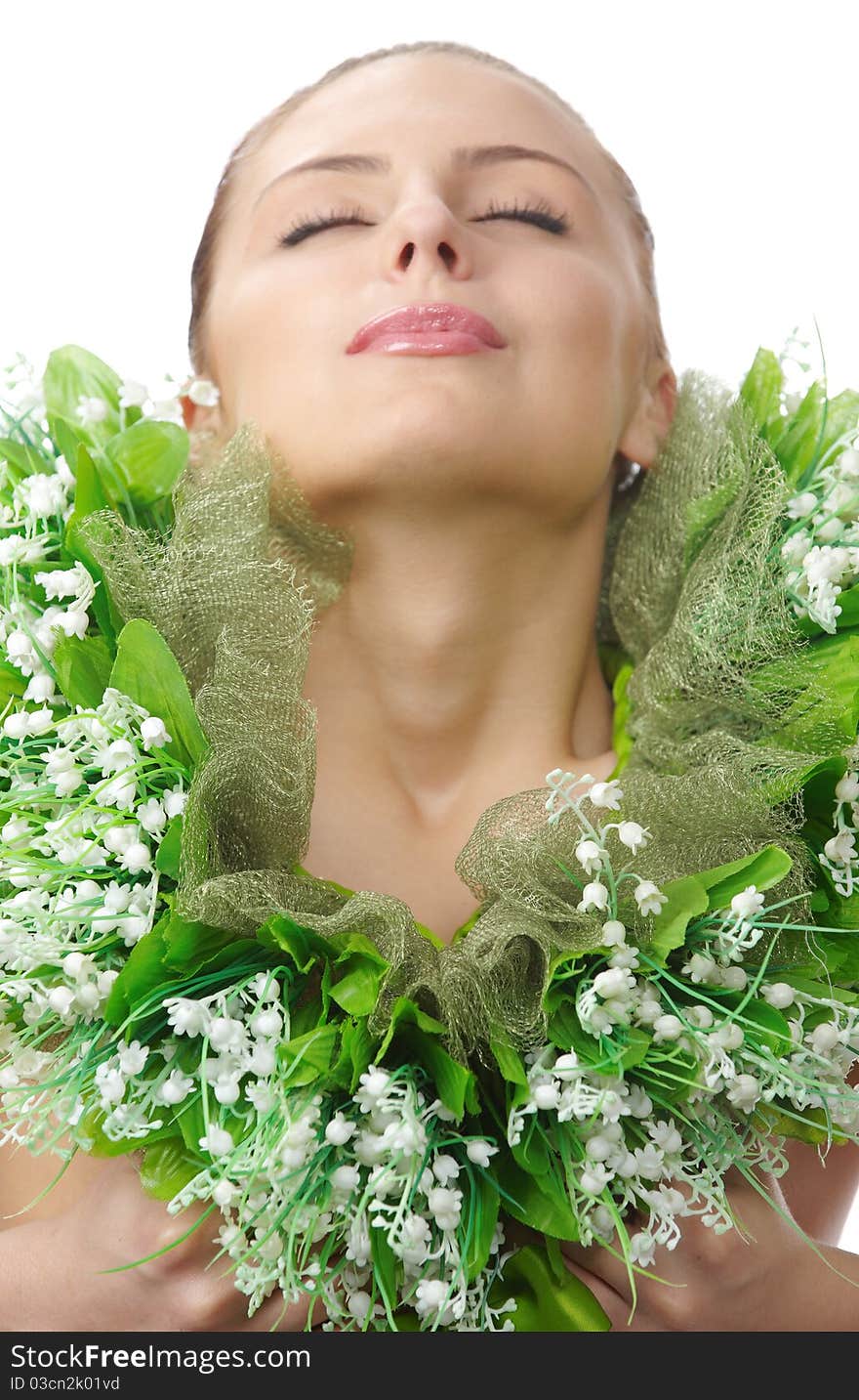 Close up portrait of naked tender spring woman covered a chaplet from the lily of the valleyc with close eyes in studio on white backgrount. Close up portrait of naked tender spring woman covered a chaplet from the lily of the valleyc with close eyes in studio on white backgrount