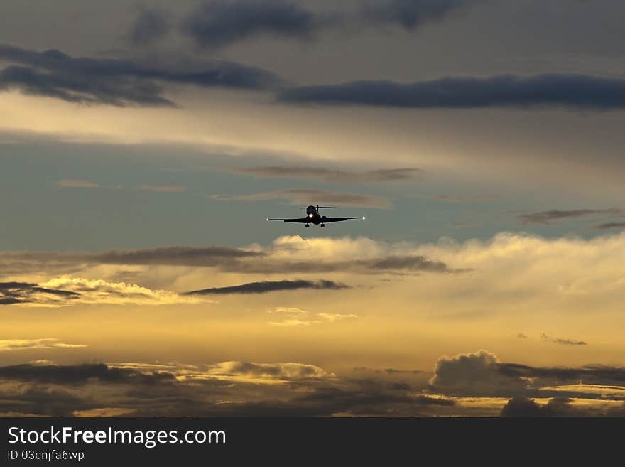 Aircraft in final approach to airport at dusk