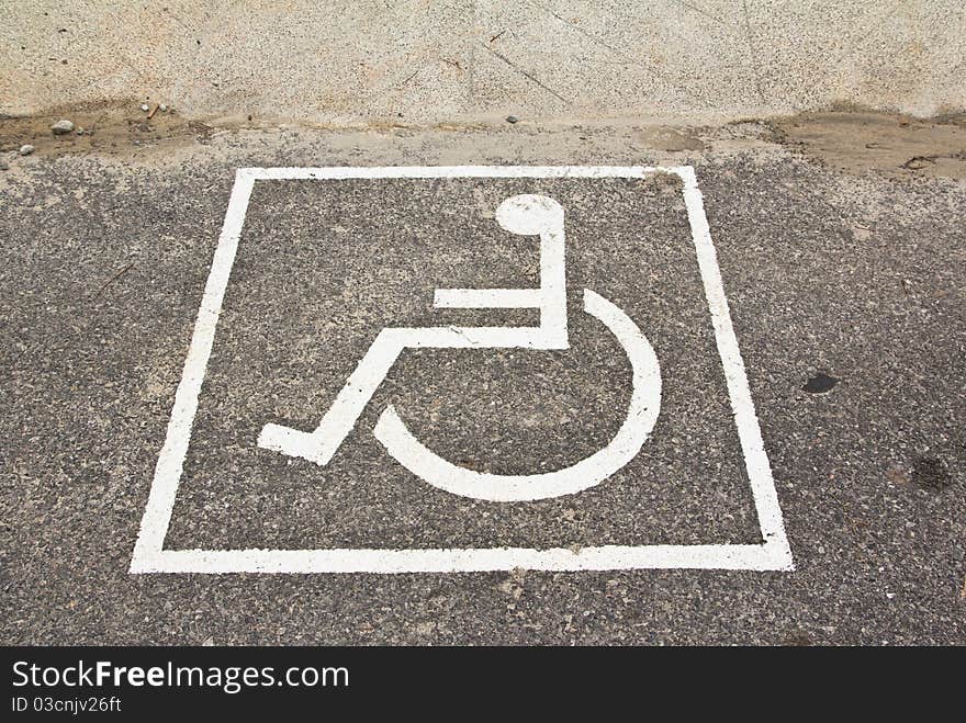 Modern disabled sign at a street on asphalt. Modern disabled sign at a street on asphalt