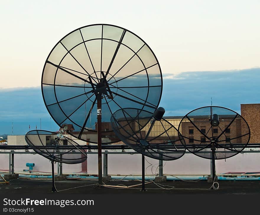 Black Satellite dish on high building in ChiangMai Thailand.