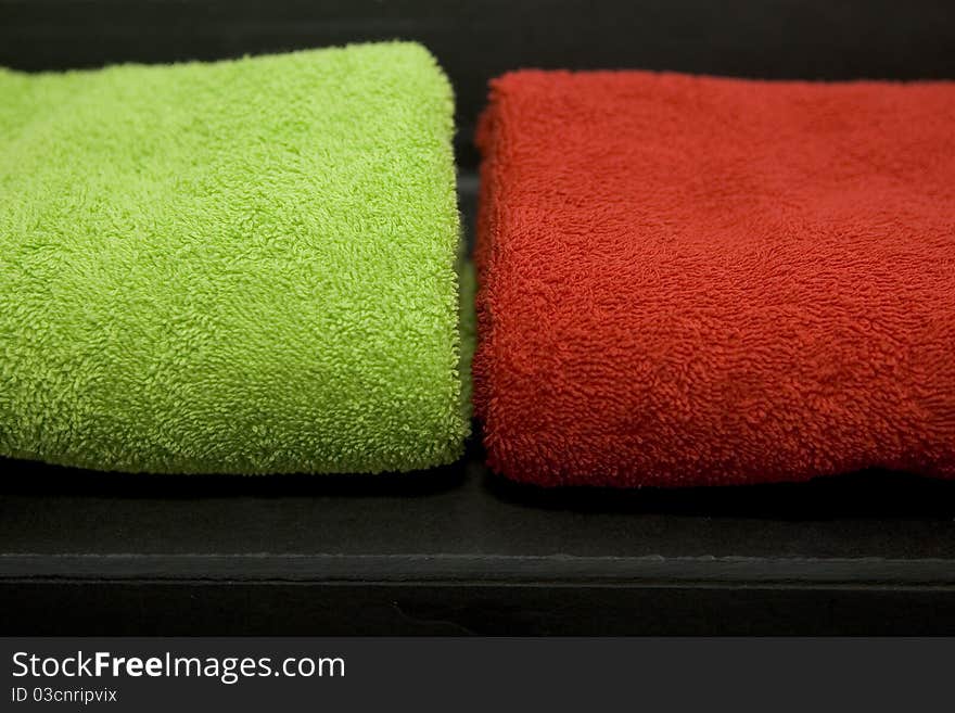 These are two colorful towels on a slate plate