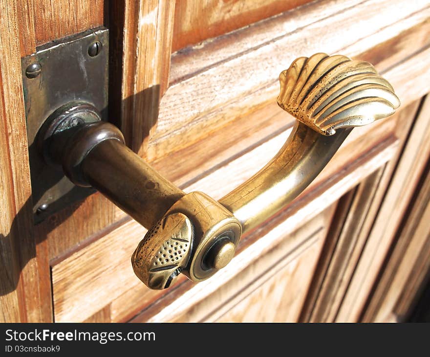 An old door handle on a wooden door