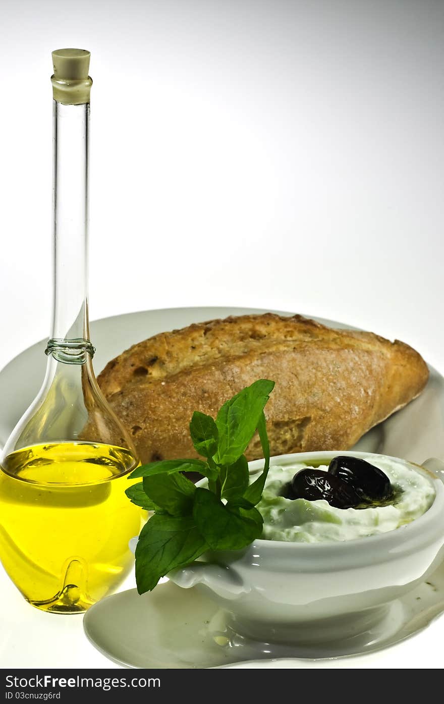 Traditional Greek dip tzatziki, olive oil and bread roll