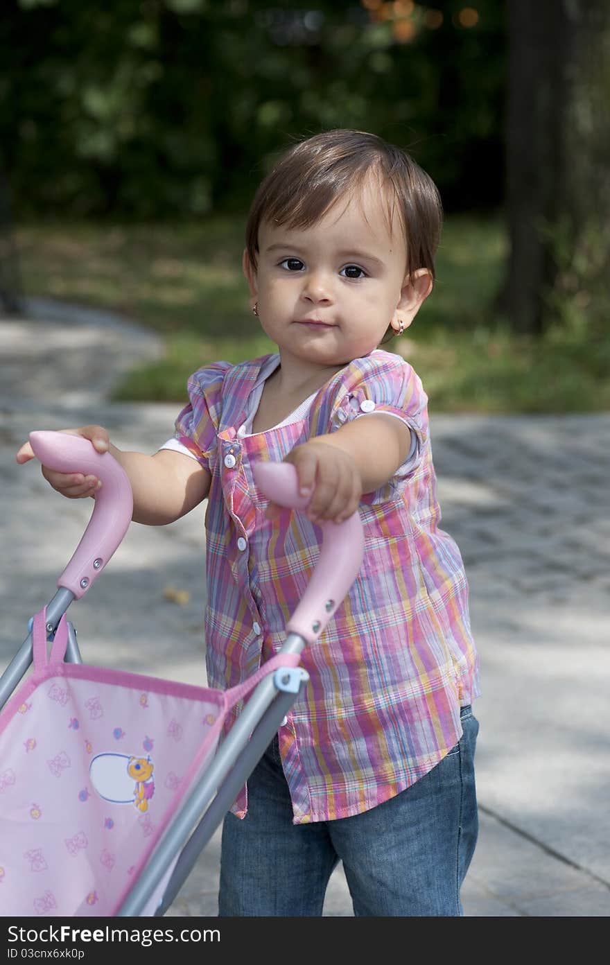 Smiling girl on the alley looking left at camera