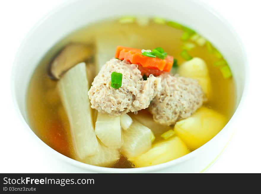 Vegetable soup with pork in white bowl