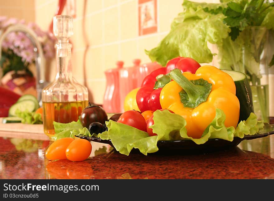 Fresh vegetables and olive oil on a kitchen table. Fresh vegetables and olive oil on a kitchen table