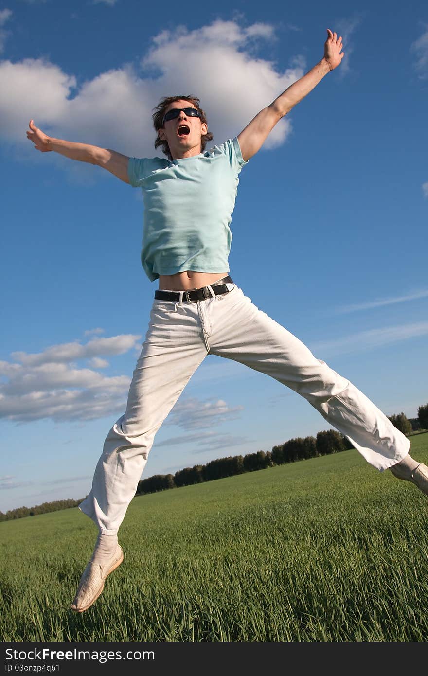 Young man is jumping outdoors