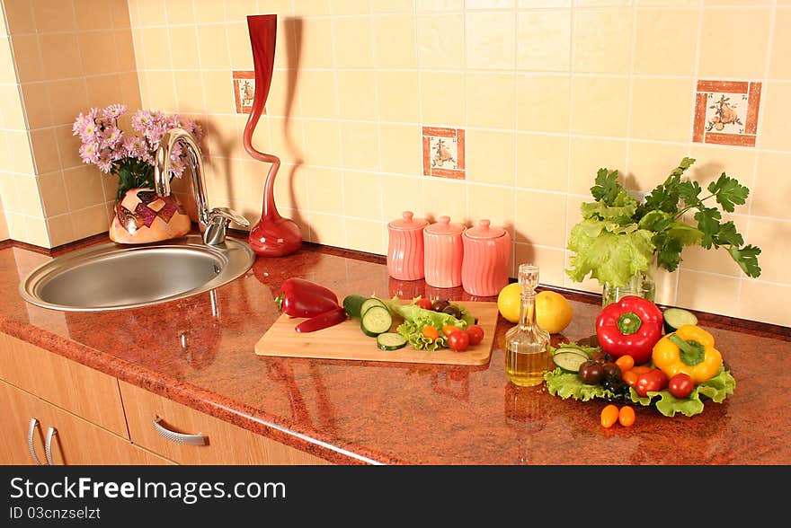 Fresh vegetables and olive oil on a kitchen table. Fresh vegetables and olive oil on a kitchen table