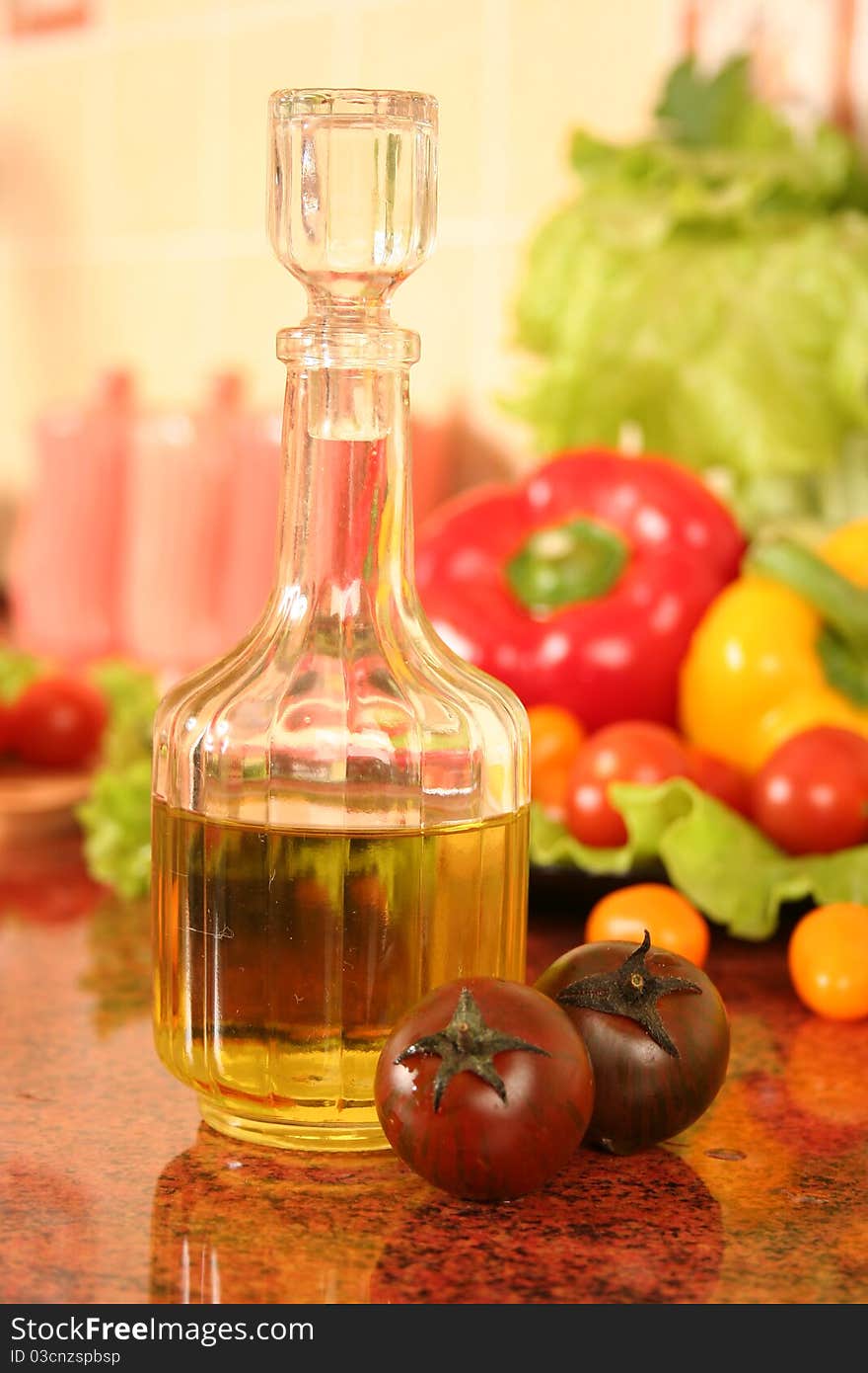 Fresh vegetables and olive oil on a kitchen table. Fresh vegetables and olive oil on a kitchen table