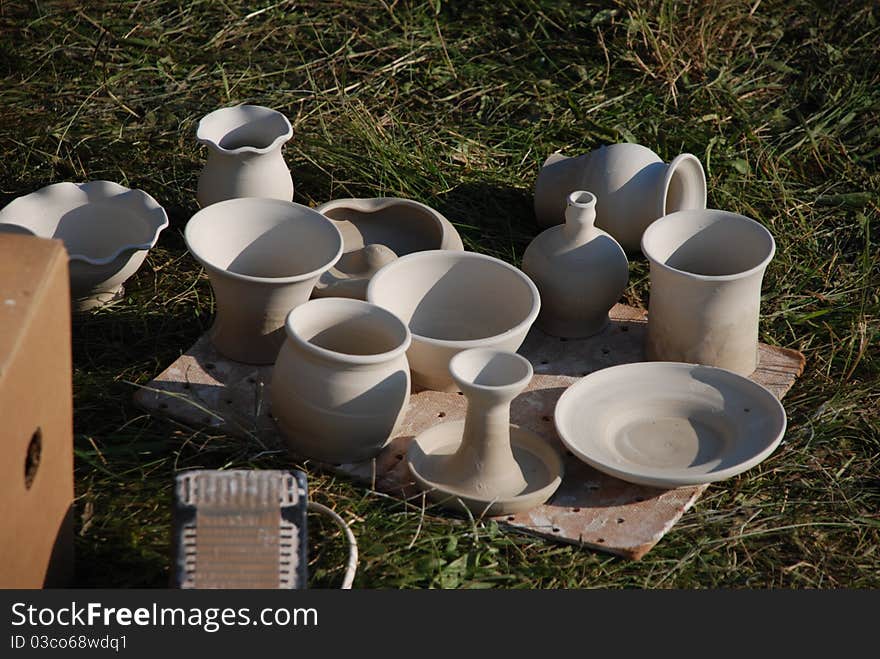 Handmade ceramics on grass background