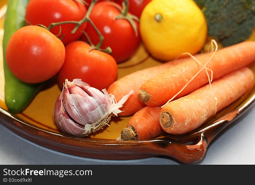 Vegetables in an earthenware dish. Vegetables in an earthenware dish.