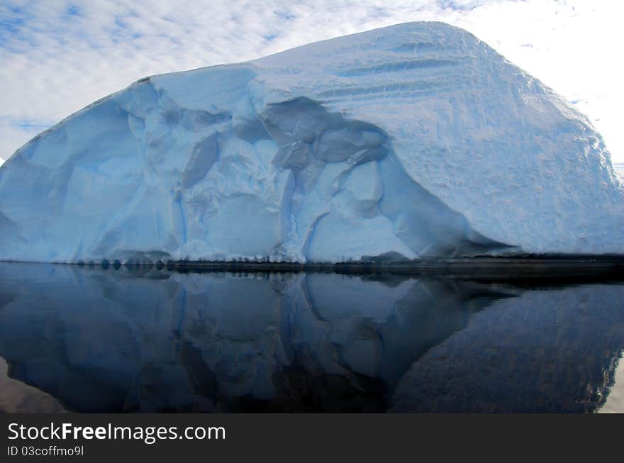 Iceberg reflected in dark ocean. Iceberg reflected in dark ocean