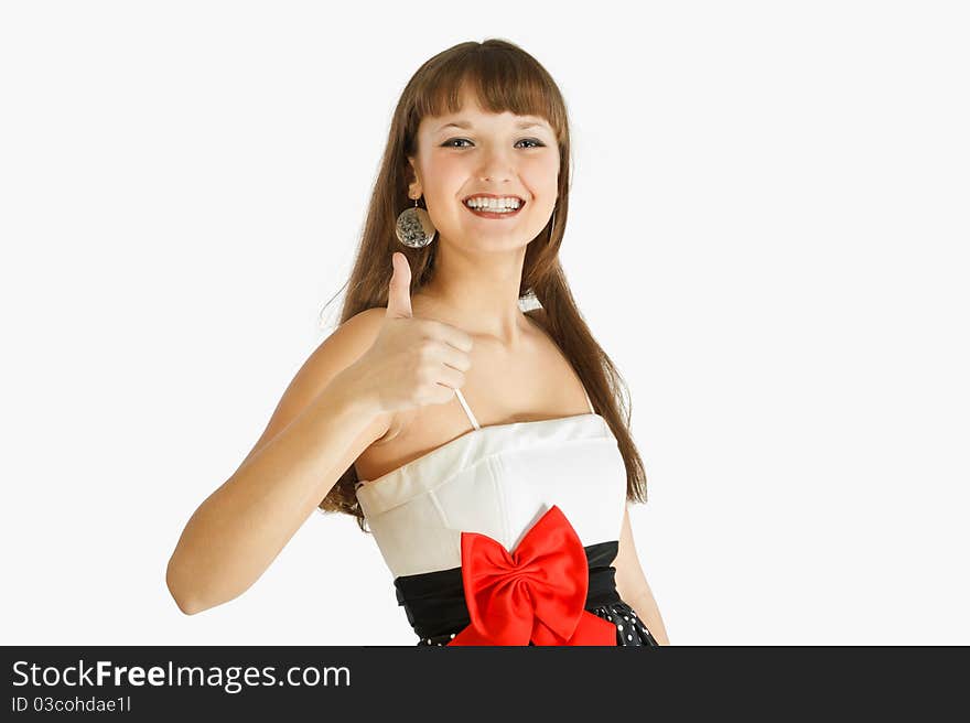 Beautiful Fashion Girl Smiling and showing thumb up. Landscape. Close-up. A look at the camera. Black skirt with white polka dots. Topic white with a red bow at the waist. On a white background. Beautiful Fashion Girl Smiling and showing thumb up. Landscape. Close-up. A look at the camera. Black skirt with white polka dots. Topic white with a red bow at the waist. On a white background.