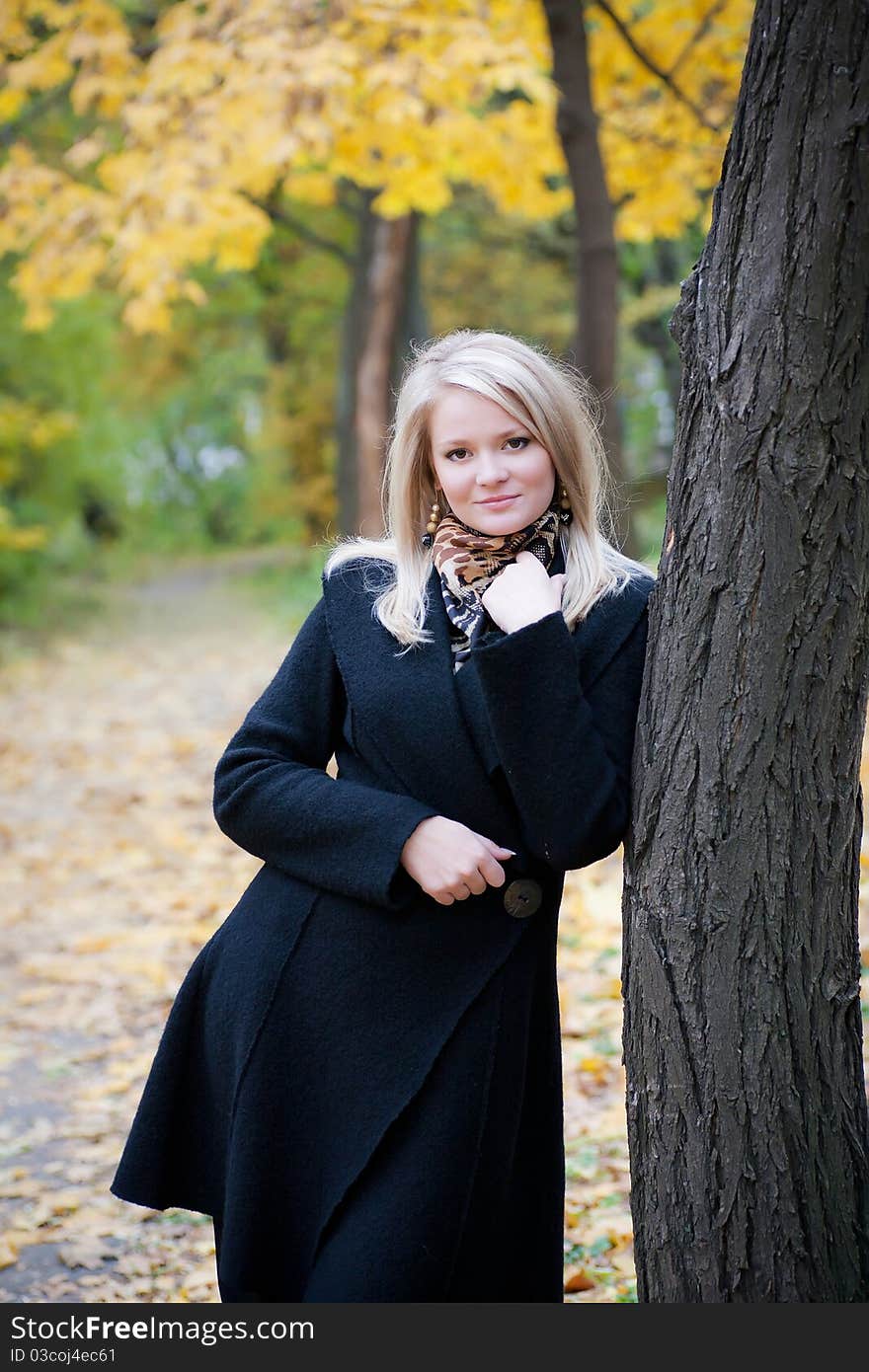 Portrait of a girl standing near a tree