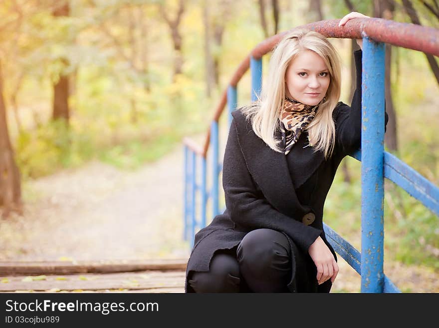 Autumn portrait of blonde girl on the Bridge. Autumn portrait of blonde girl on the Bridge