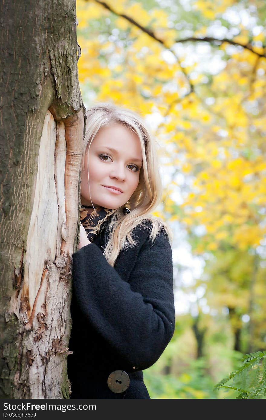 Portrait of a girl standing near a tree. Portrait of a girl standing near a tree