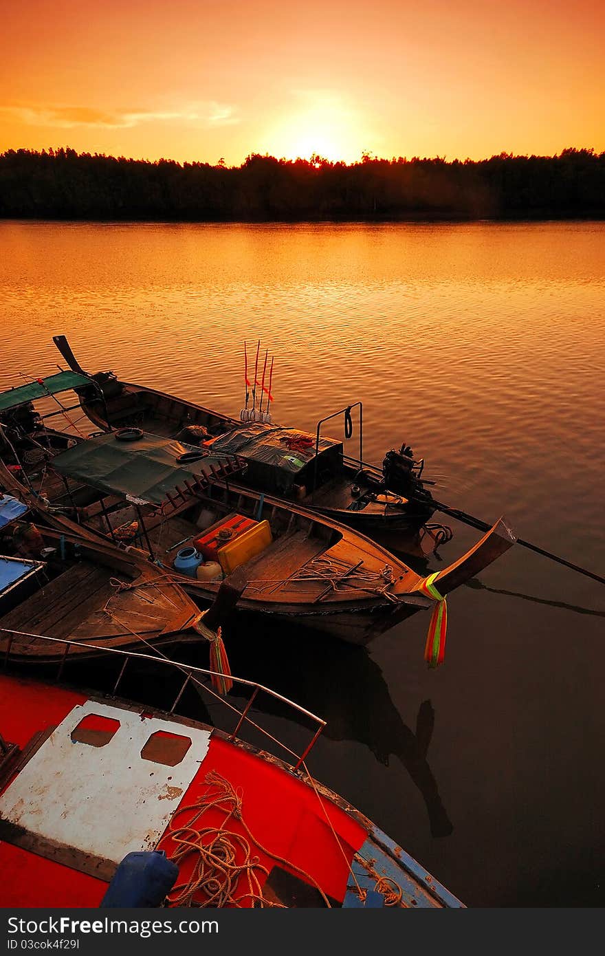 Fishing boat on river at sunrise