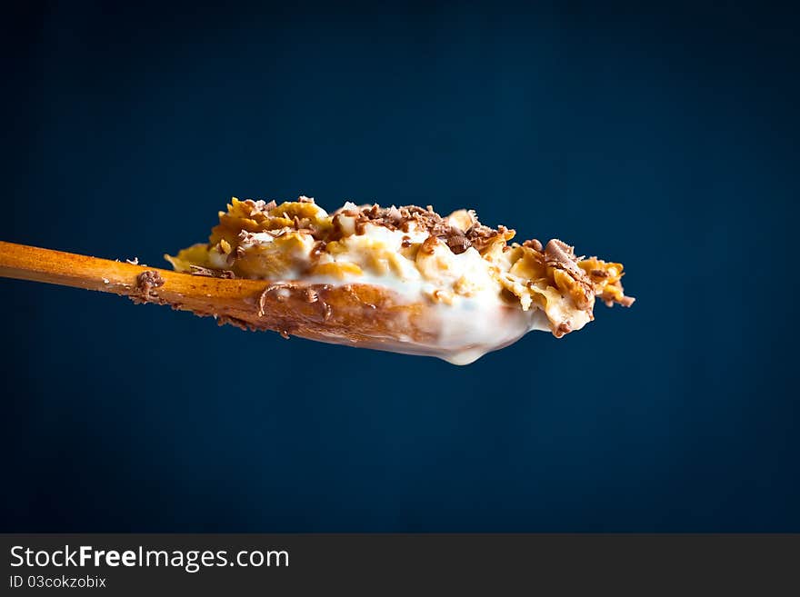 Spoon of corn flakes with chocolate