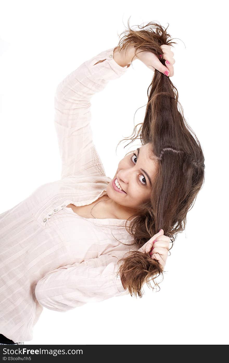 A young girl having fun and pulling her long hair