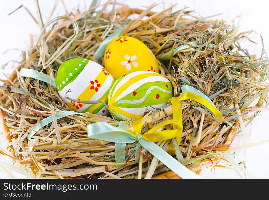 Closeup basket with colorful Easter Eggs isolated in studio