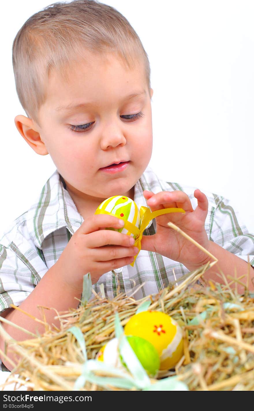 Little boy with easter eggs in basket