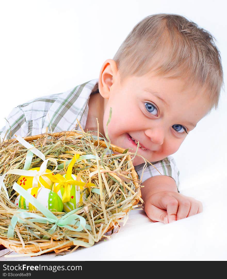 Little boy playing with easter eggs in basket. Little boy playing with easter eggs in basket