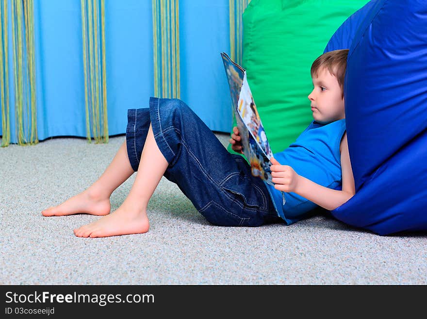 Little smiling boy is playing on a floor at home. Little smiling boy is playing on a floor at home.