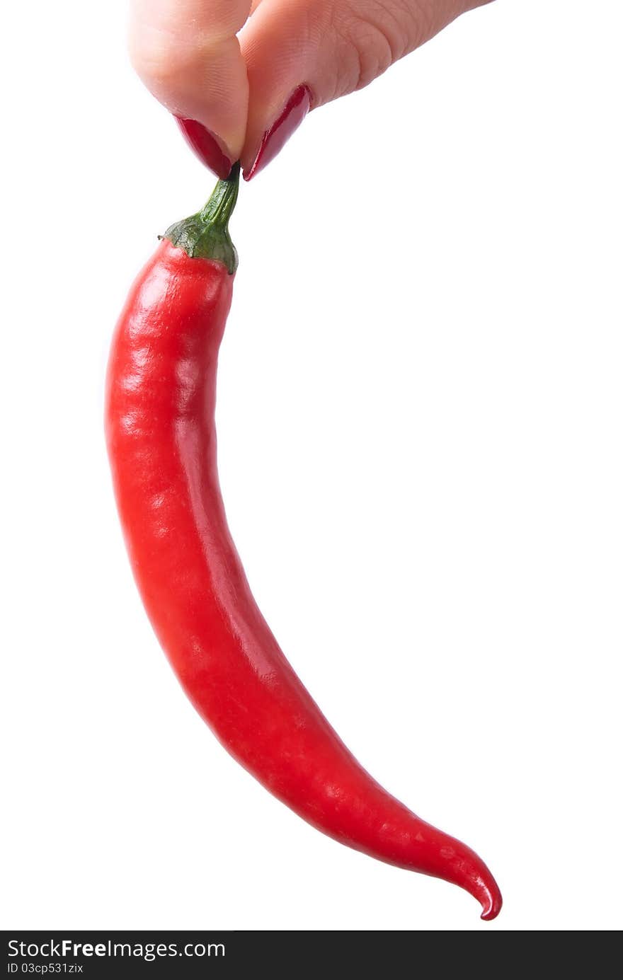 Two fingers holding a red hot peppers on a white background