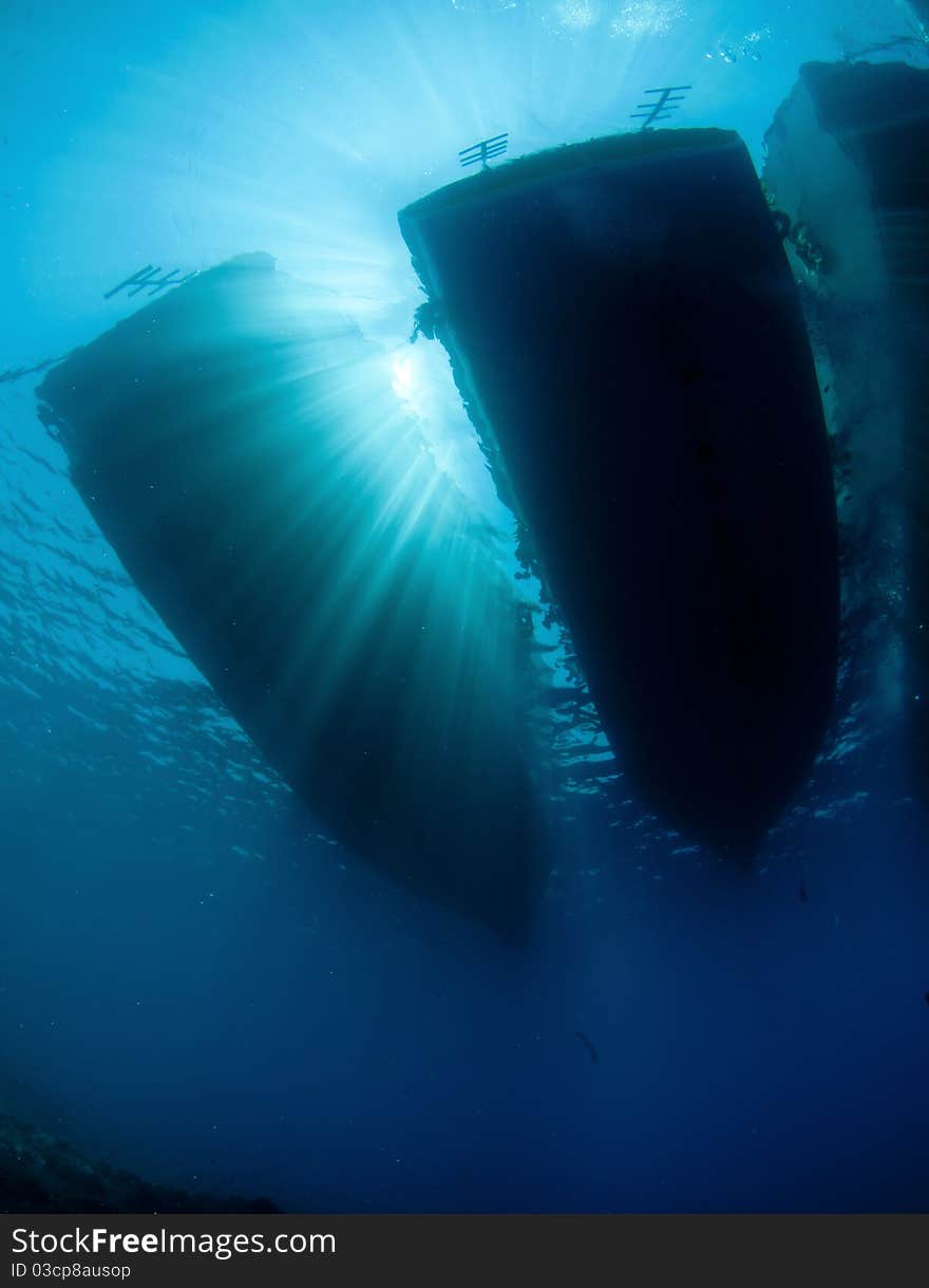 Scuba diving boats with ray of sunlight from under the water. Scuba diving boats with ray of sunlight from under the water