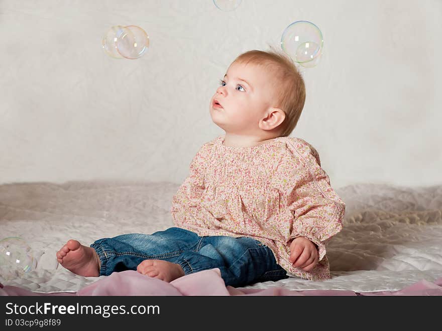 Closeup portrait of little cute baby girl with bubbles. Closeup portrait of little cute baby girl with bubbles