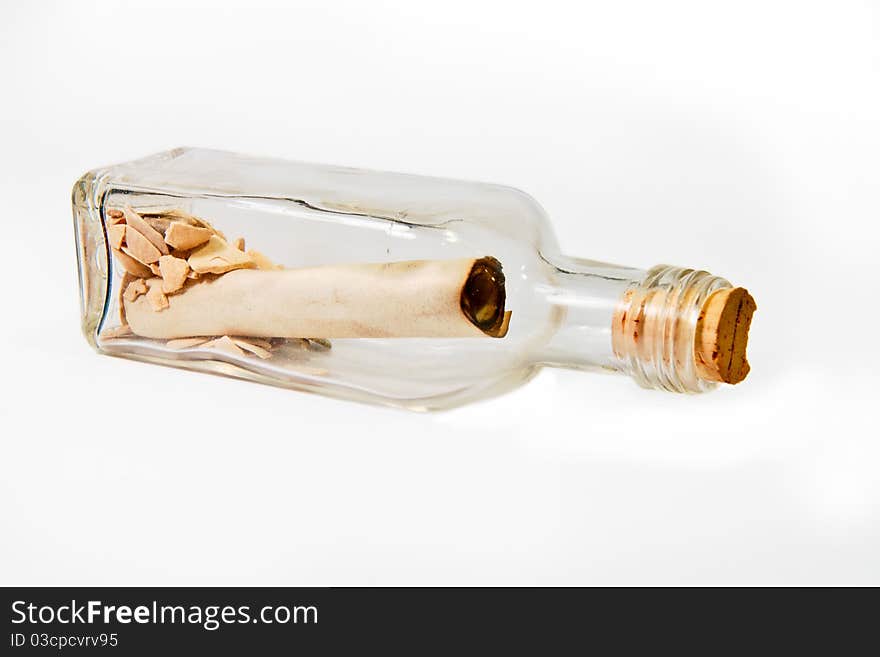 A message written in a scroll inside a bottle with some rocks. A message written in a scroll inside a bottle with some rocks