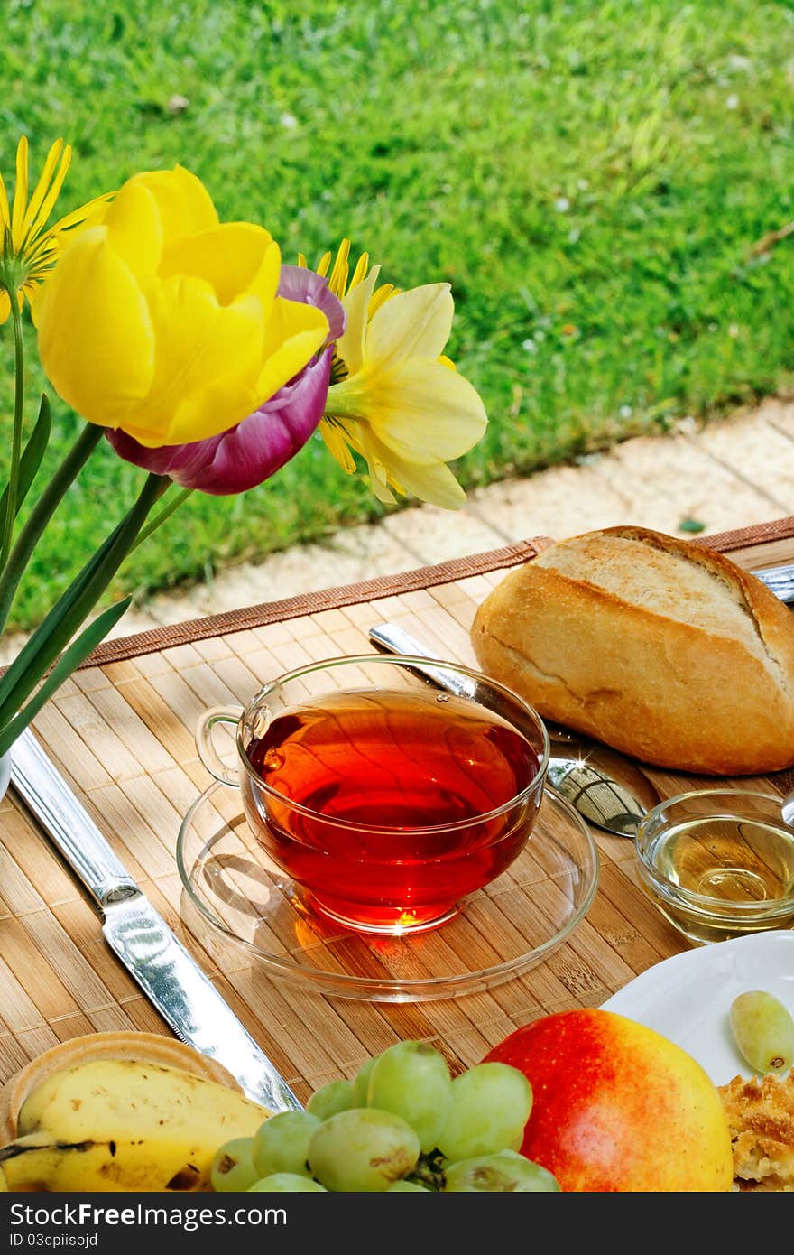 Tea and simple food on a wooden table in the garden. Tea and simple food on a wooden table in the garden.