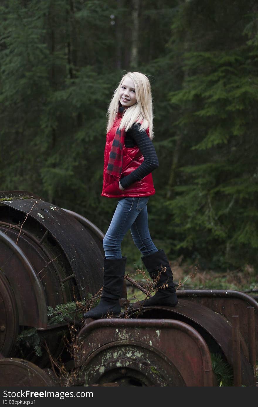 Beautiful young teenage girl sitting on her suitcase in the middle of railroad tracks. Beautiful young teenage girl sitting on her suitcase in the middle of railroad tracks.