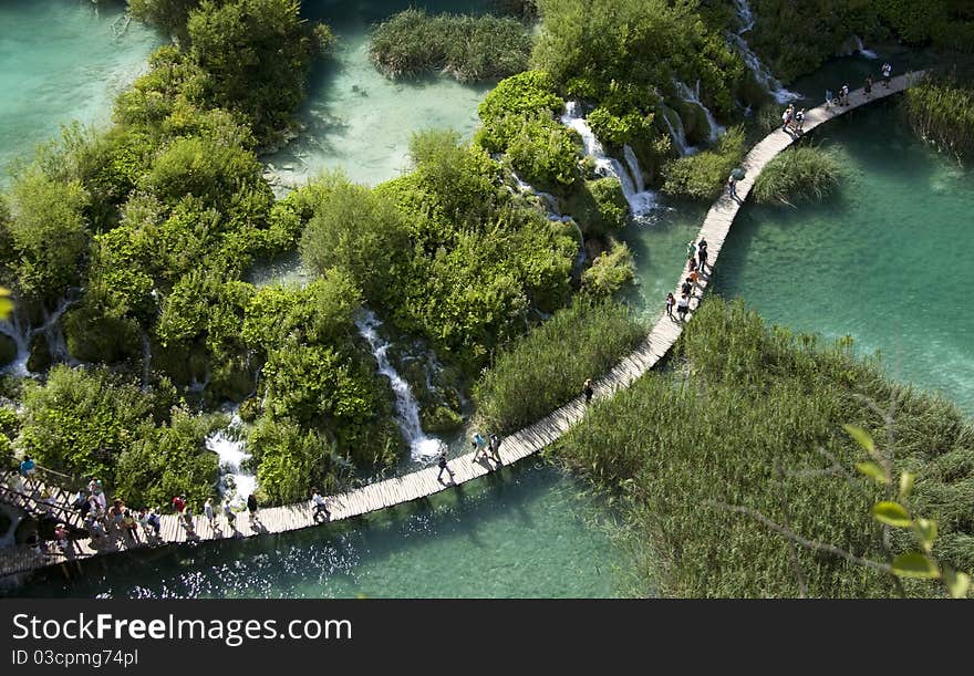 Wooden pathway in the forest next to a stream in Plitvice Lakes of Croatia