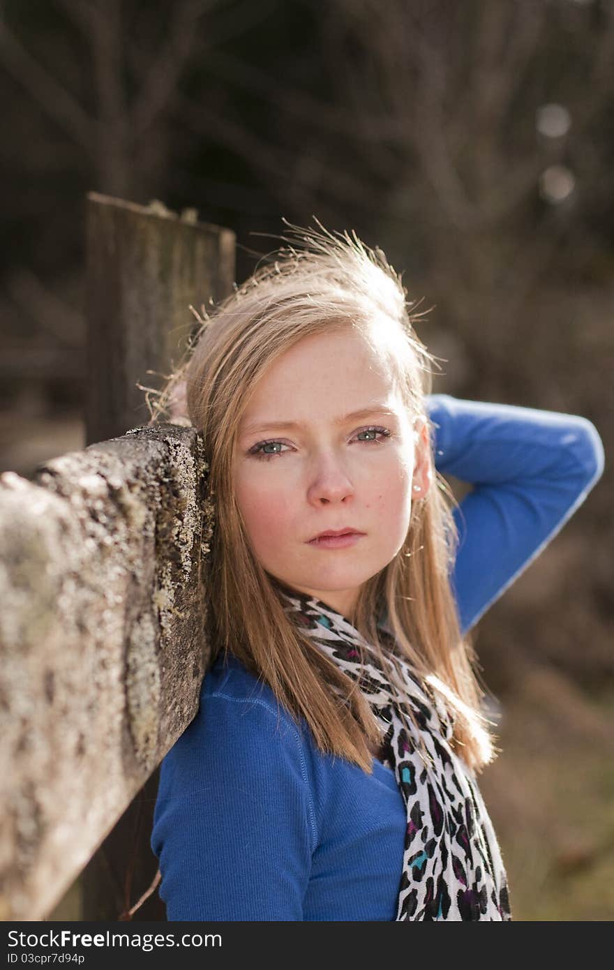 A Young Girl on a fence, feeling sad. A Young Girl on a fence, feeling sad